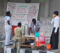 Palm reading in India: an indian palmist at work.