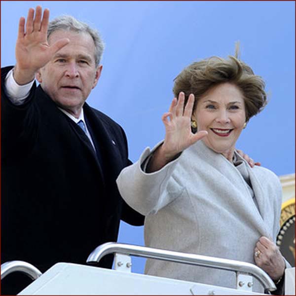 Former US president George W Bush: hand waving with Laura Bush photo.